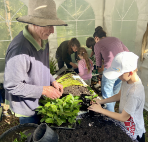 Andrew teaching kids how to pot up and care for native plants