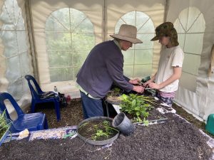 Andrew teaching kids how to pot up and care for native plants